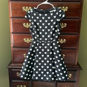 Alice + Olivia black cap sleeve wool dress with white heart pattern.